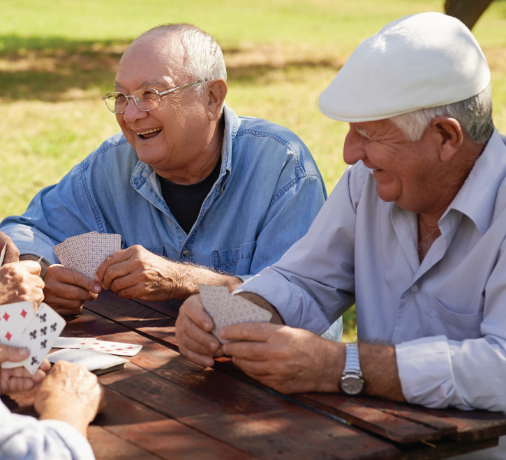 Senior men playing cards outside