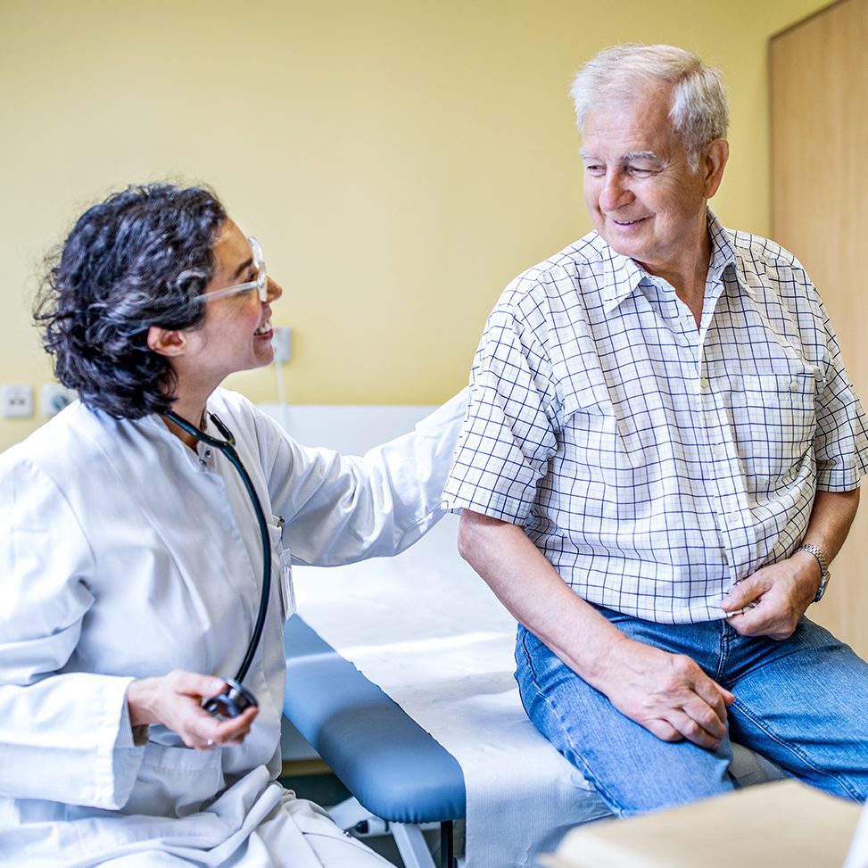 Medical staff tending to a senior male patient