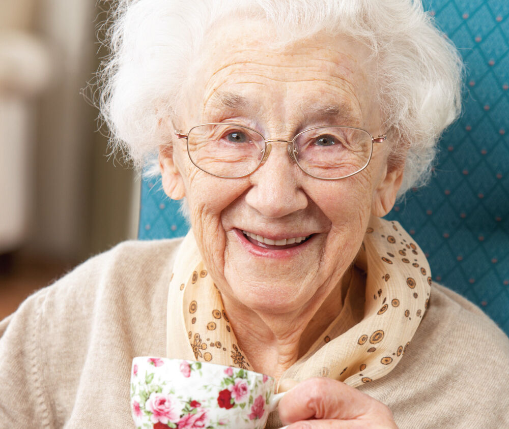 Happy Senior Woman drinking a warm cup of tea