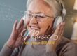 Smiling senior woman listening to music on her headphones